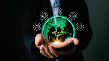 hand hold hologram to save energy,and reduce global warming,climate change,ecology friendly investment,ESG environment social governance,Green Business Innovation and Sustainable Development concept. photo