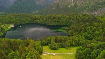 Drone views of Freibergsee and Heini-Klopfer- Schkiflugschanze in Bavaria, Germany. Surrounded by mountains and forests, this pristine lake and famous ski jump is an aerial view of area. Oberstdorf. video