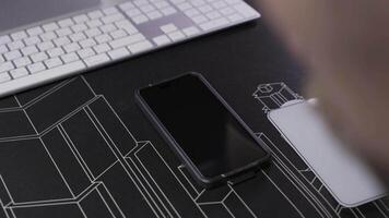 Close-up of male hand preparing and installing screen protector on smartphone. Top view of attaching protective sheet to smart phone display. Tempered glass shield protector. Maintenance and repairing video
