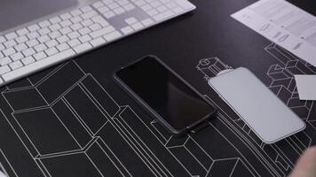 Close-up of male hand preparing and installing screen protector on smartphone. Top view of attaching protective sheet to smart phone display. Tempered glass shield protector. Maintenance and repairing video