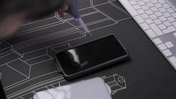 Close-up of male hand preparing and installing screen protector on smartphone. Top view of attaching protective sheet to smart phone display. Tempered glass shield protector. Maintenance and repairing video