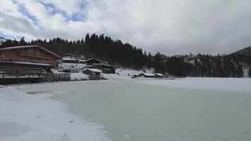 Lake Spitzingsee in winter covered with snow and ice in freezing cloudy weather in Bavaria, Germany. A mountain lake in Bavarian Alps frozen around mountain in Spitzingsee, Schlierseer Berge video