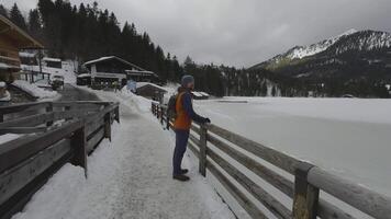 Lake Spitzingsee in winter covered with snow and ice in freezing cloudy weather in Bavaria, Germany. A mountain lake in Bavarian Alps frozen around mountain in Spitzingsee, Schlierseer Berge video