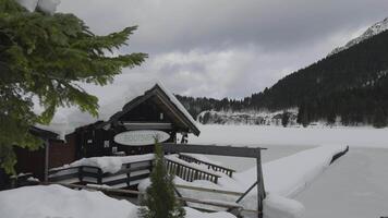 Lake Spitzingsee in winter covered with snow and ice in freezing cloudy weather in Bavaria, Germany. A mountain lake in Bavarian Alps frozen around mountain in Spitzingsee, Schlierseer Berge video