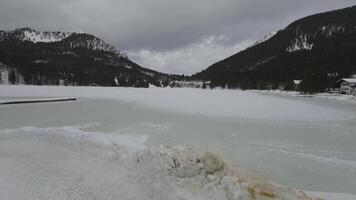 Lake Spitzingsee in winter covered with snow and ice in freezing cloudy weather in Bavaria, Germany. A mountain lake in Bavarian Alps frozen around mountain in Spitzingsee, Schlierseer Berge video