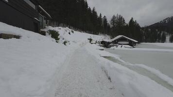Lake Spitzingsee in winter covered with snow and ice in freezing cloudy weather in Bavaria, Germany. A mountain lake in Bavarian Alps frozen around mountain in Spitzingsee, Schlierseer Berge video