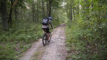 Man ride bicycle through forest, collecting trash. Trendy sports programs plogging that help preserve environment. Pollution. Ecological problem. Plastic ban awareness, national cleaning day concept. video