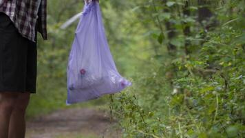Young man throwing litter garbage from plastic bag on ground. Environmental pollution. Global warming. Male throwing out garbage in forest. Ecological issue. Throw trash anywhere. Contaminated soil. video