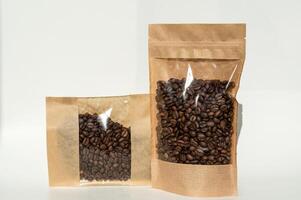 A kraft paper bag with coffee beans for viewing with a highlighted shadow lies on a white background photo