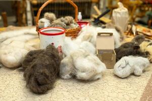 Wool fibers for crafting with basket, yarn, and natural materials on display photo