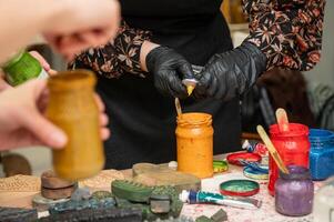 Artistic workshop with female hands creating colorful craft prints photo