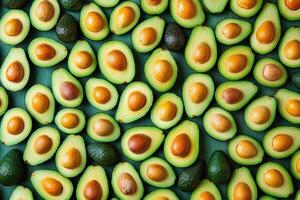 Fresh avocados whole and halved creating a vibrant green pattern photo