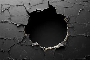 Cracks forming large hole on dark gray wall creating deep void photo