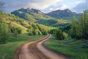 Winding dirt road leading into the majestic mountains photo