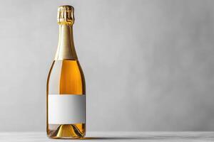 Champagne bottle with blank label standing on table against neutral background photo
