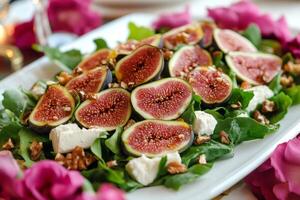 Delicious fig salad with goat cheese and walnuts being served on a white rectangular plate photo