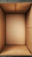 Open empty cardboard box on wood table, ready for shipping photo