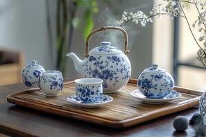 Steaming teapot and teacups on bamboo tray, creating relaxing atmosphere photo