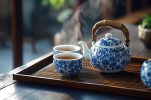Steaming teapot and two teacups on wooden tray, creating relaxing atmosphere photo