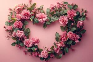 Pink roses forming heart shape on pink background for valentine's day photo