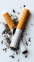 Two broken cigarettes with ashes symbolizing quitting smoking photo
