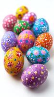 Twelve colorful hand-painted easter eggs forming a square on white background photo