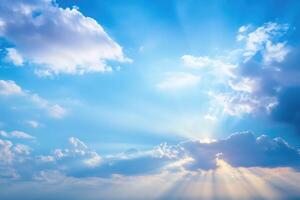 Blue sky background with white clouds and sun rays. Nature composition. photo