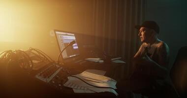 Man plugging out cord of guitar in studio video