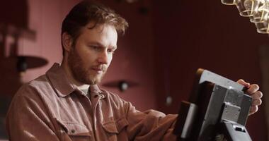 Wine bar owner using computer at counter checking orders video