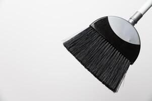 cropped view of floor broom handle on grey background, close-up of cleaning item photo