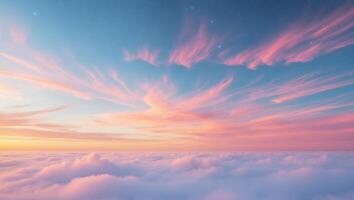 A beautiful sunset over the clouds with pink and blue clouds photo