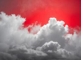 A red sky with clouds and a bright sun photo