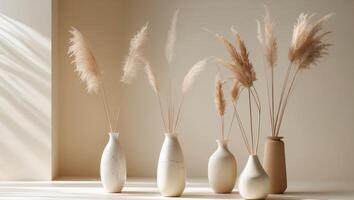 Five vases with tall grass in them photo