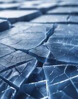 Cracked ice surface with deep blue texture and sharp highlights photo