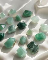 Set of Jade Gemstones in Various Shades of Green on Soft Velvet Surface photo