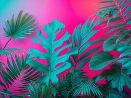 Trendy turquoise colored close up of various tropical leaves on bright pink and violet background photo