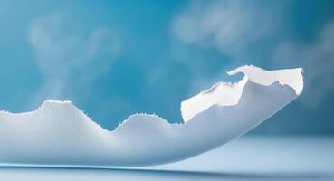 Torn White Paper Effect on Blue Background with Curved Edges photo