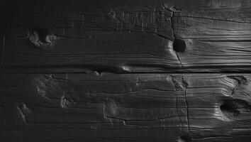 A black and white photo of wood with holes