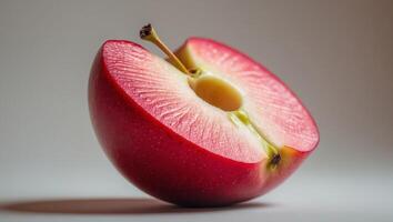 Juicy red apple slice with a smooth texture. photo