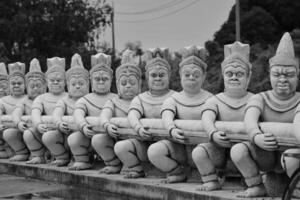 Bangkok, Thailand on 23 July 2023. Row of Intricate Stone Statues in Black and White photo