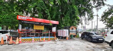Bekasi, Indonesia on 1 July 2024. Commuter Bike Shelter in Urban Setting with Traffic Control photo