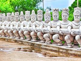 Bangkok, Thailand on 23 July 2024. Ancient Thai Statues Carrying a Burden, Park Setting photo