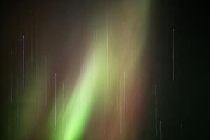 Aurora borealis in red and green and stars with motion blur effect photo