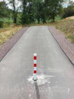 End of a small road with a red and white bollard in Germany photo