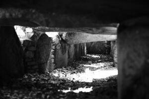 Black and white image of corridor in the prehistoric dolmen Kuechentannen in Germany photo