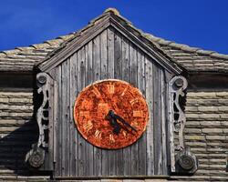 Rusty turret clock on a sunny day photo