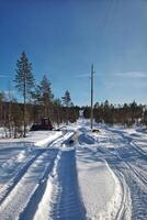 Renovation of power line in northern Sweden with a tracked vehicle photo