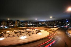 Long exposure shot of traffic circle in the winterly city of Umea in Sweden photo