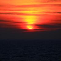 Dark orange shot of sunset over the Baltic Sea photo