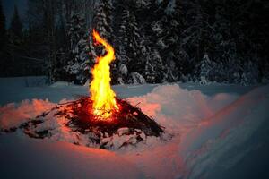 Big fire between snow heaps in winter photo